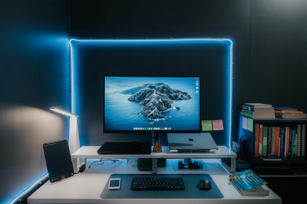 pexels-photo-13564604-13564604 Stylish home office desk setup featuring LED lights, monitor, laptop, and essentials for a productive workspace.